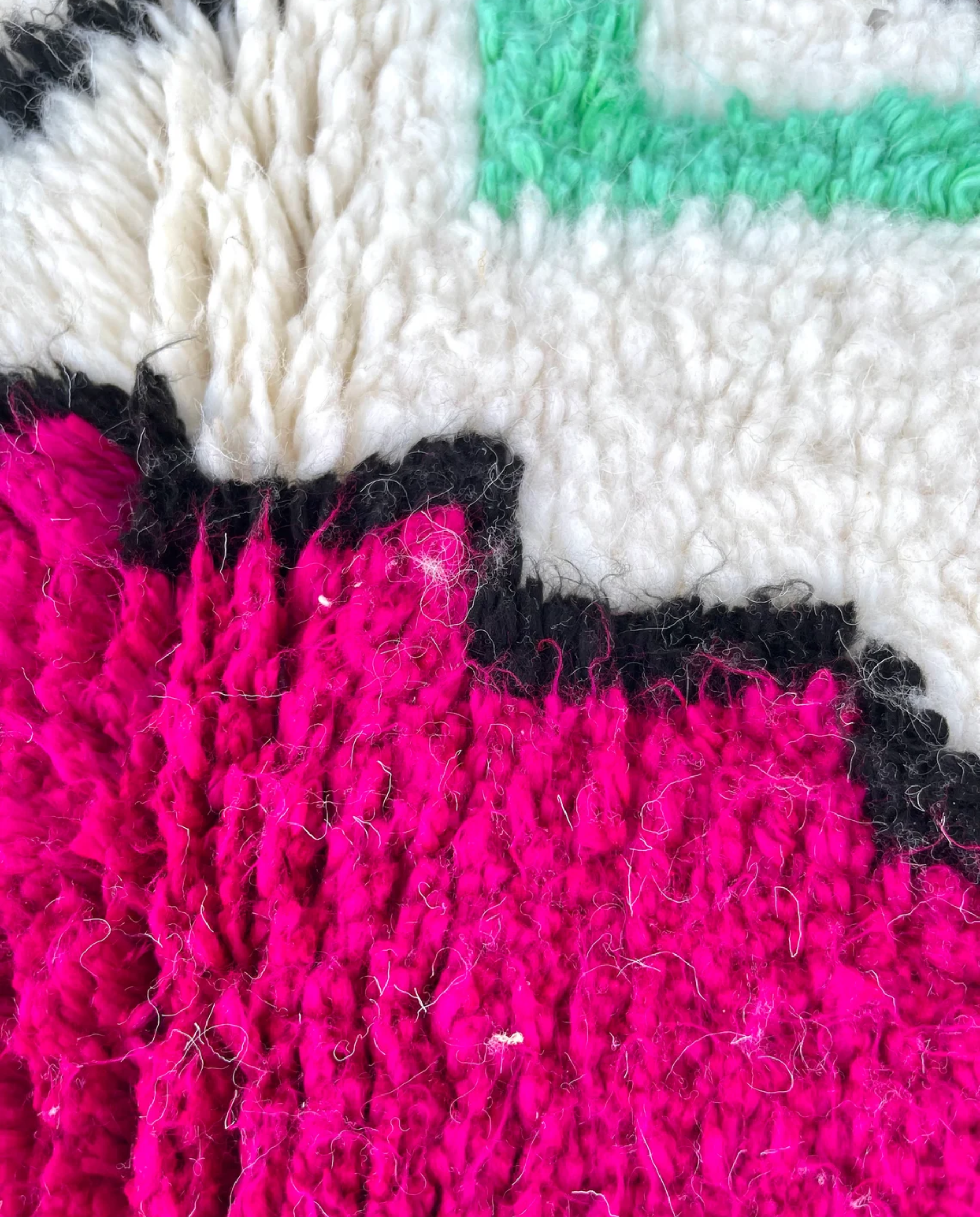 RADWA Azilal ivory scattered abstract motifs Moroccan rug close-up showing hand-knotted wool texture and pile detail 2, by NURA