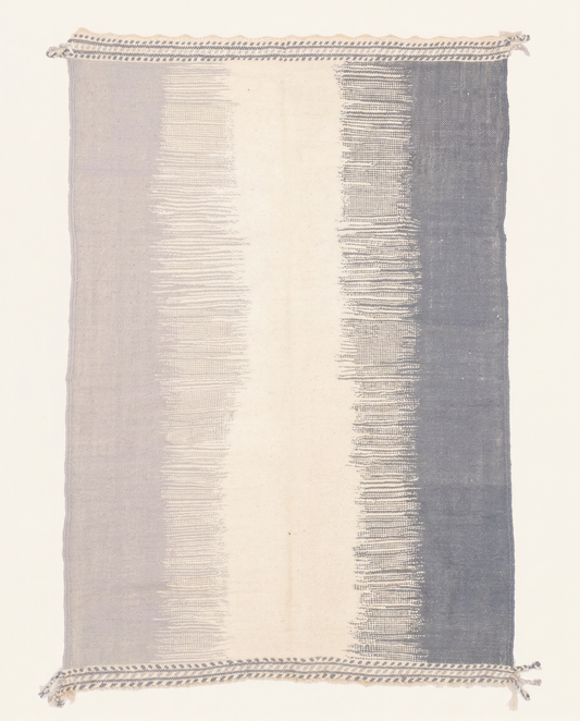 Flat-woven Taznakht Moroccan rug with wide vertical color blocks in ivory and slate blue, by NURA.
