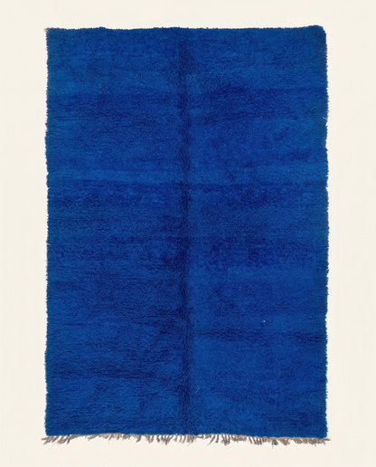 Plush solid blue Mrirt Moroccan rug with a dense high pile and natural fringe, by NURA.