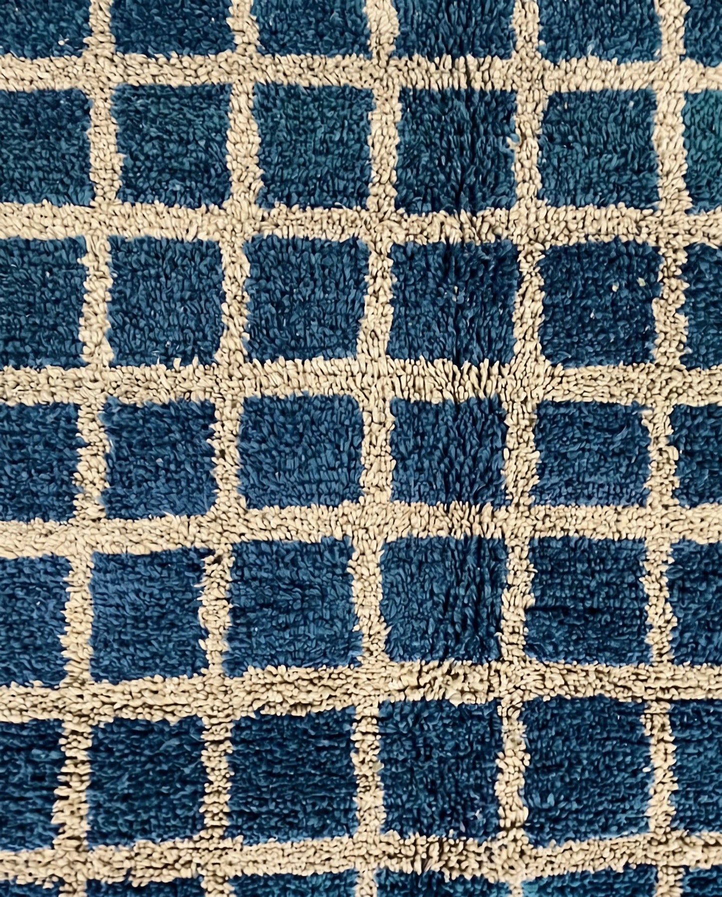 RAMA Beni Ourain navy checker grid Moroccan rug close-up showing hand-knotted wool texture and pile detail 1, by NURA