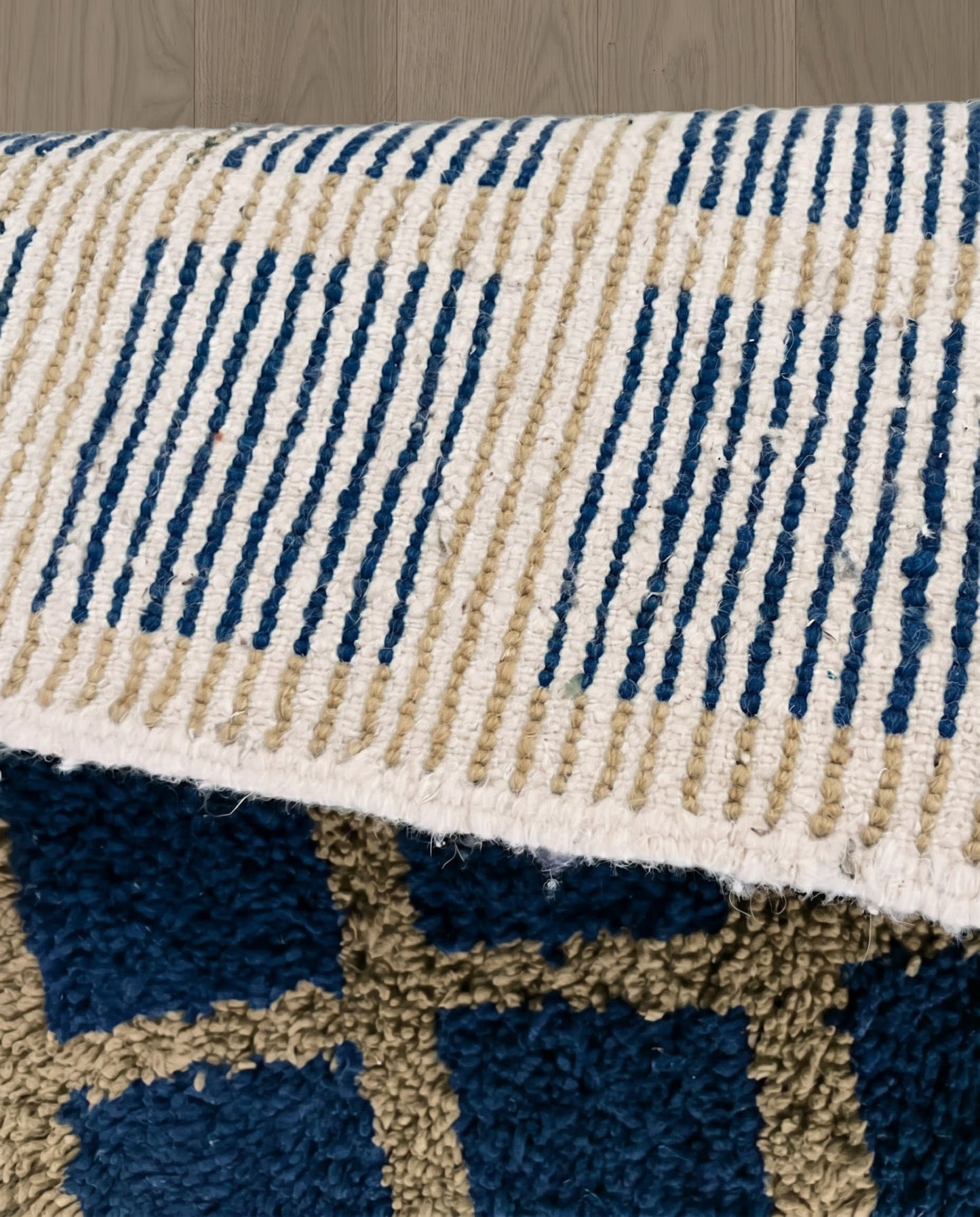 RAMA Beni Ourain navy checker grid Moroccan rug close-up showing hand-knotted wool texture and pile detail 3, by NURA