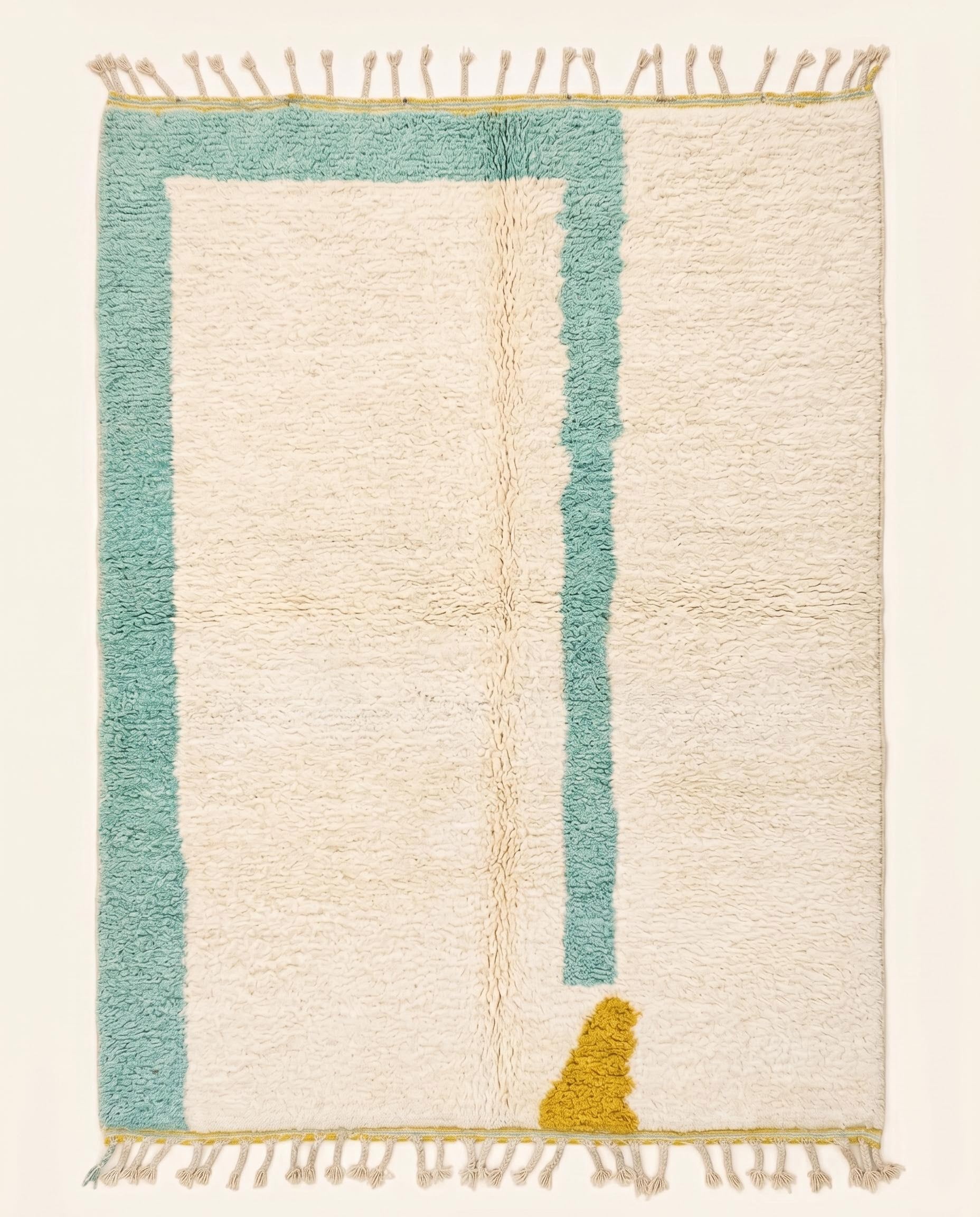 Plush modern Moroccan wool rug featuring a cream open field with an asymmetrical teal border and mustard accent, by NURA.