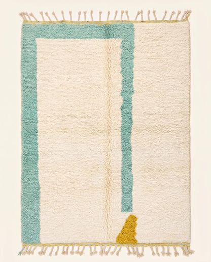 Plush modern Moroccan wool rug featuring a cream open field with an asymmetrical teal border and mustard accent, by NURA.