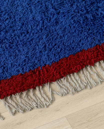 RANIA Beni Ourain cobalt solid border Moroccan rug close-up of hand-tied fringe and kilim band detail, by NURA