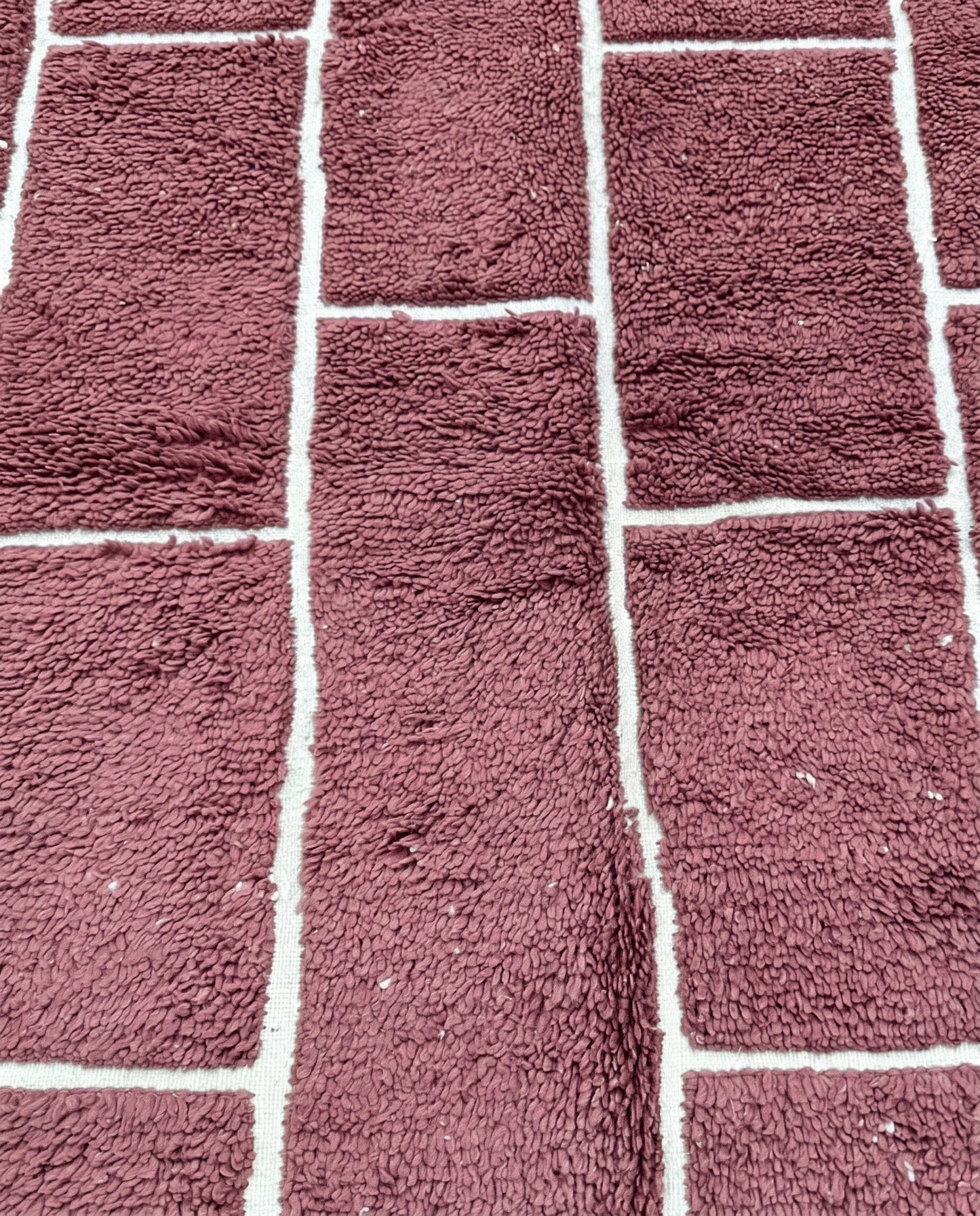 RAZANE Beni Ourain dusty rose irregular block grid Moroccan rug close-up showing hand-knotted wool texture and pile detail, by NURA