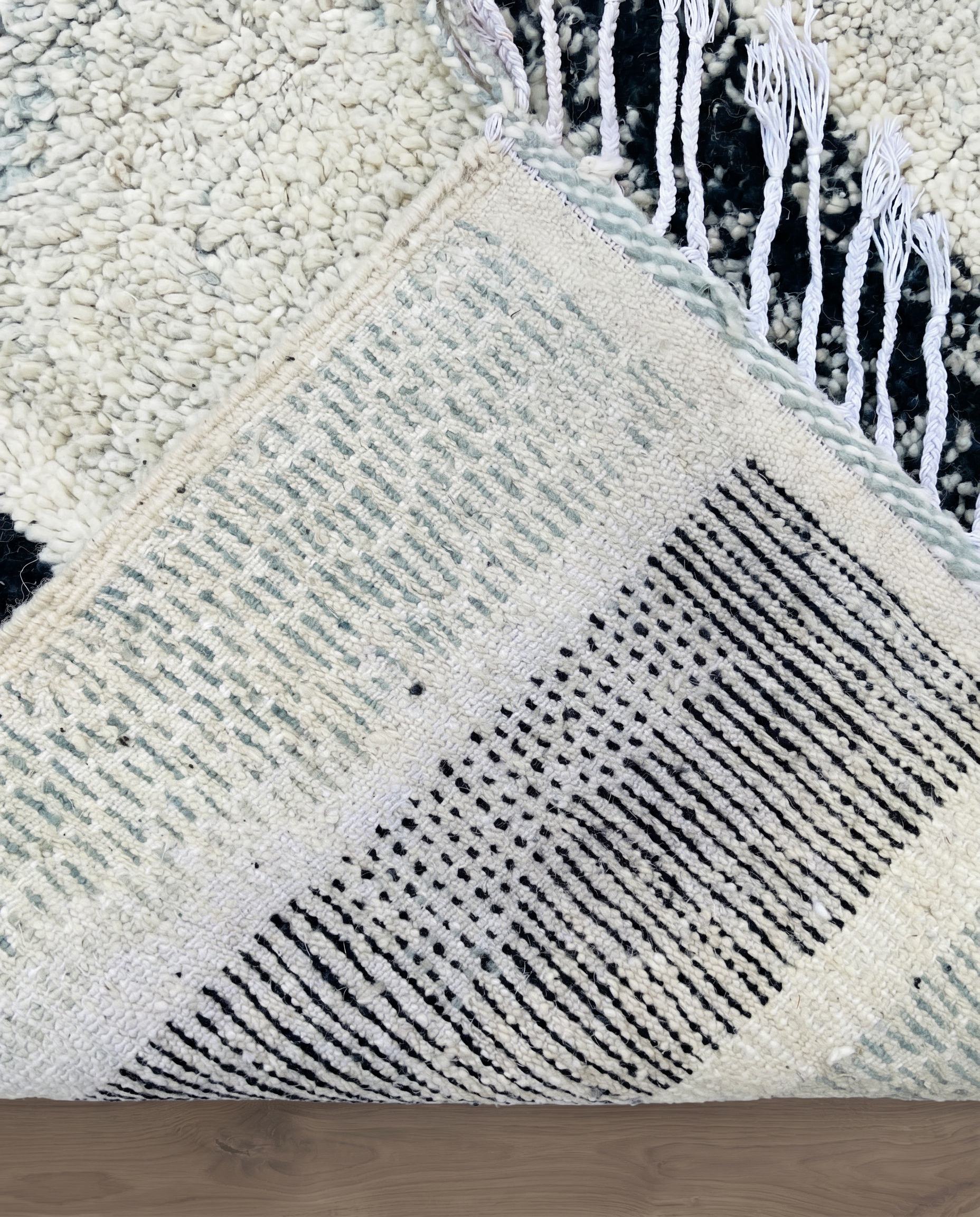 RIHAB Beni Ourain ivory irregular striped field Moroccan rug back view showing traditional handwoven construction, by NURA