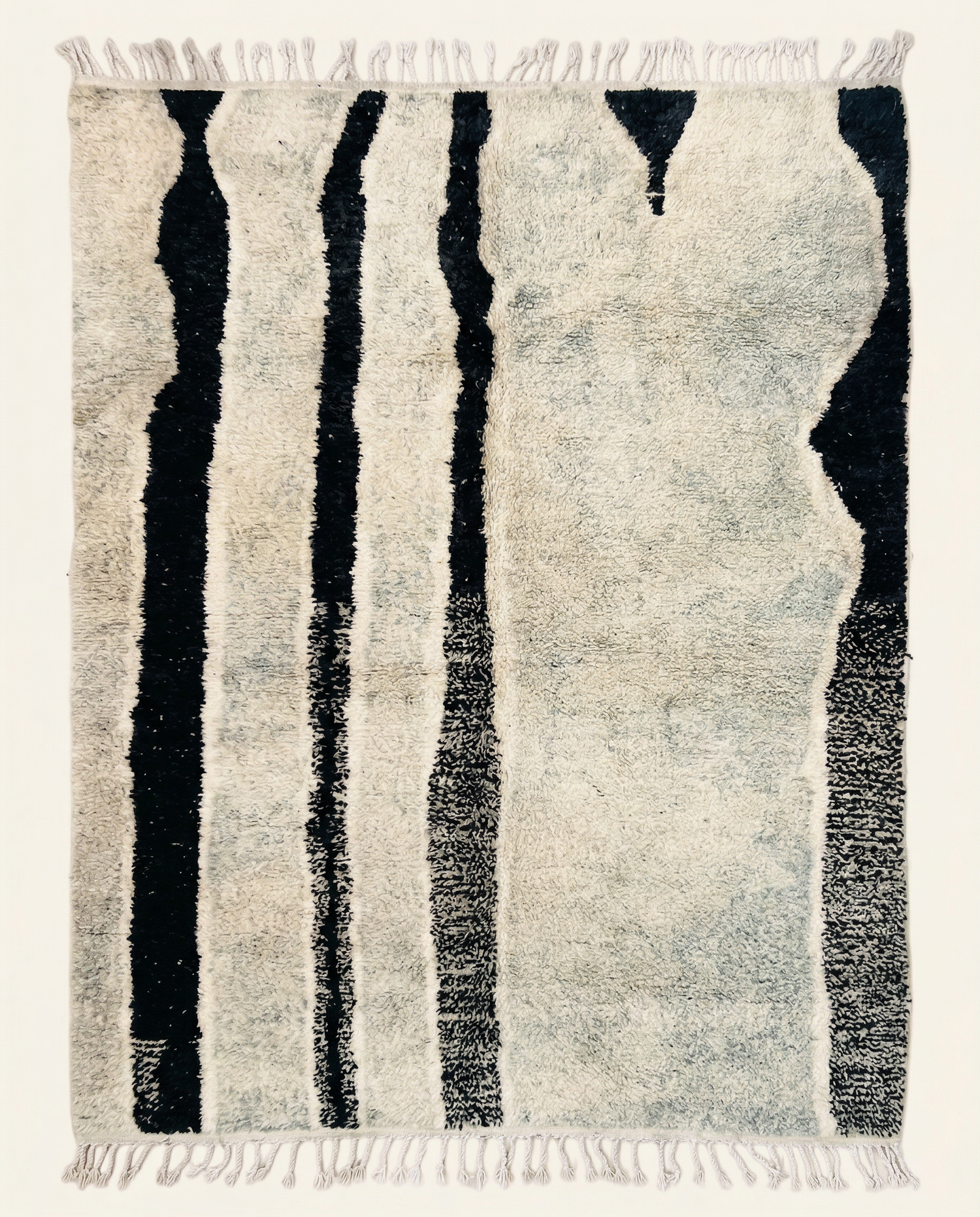 Plush ivory Beni Ourain Moroccan rug with bold irregular black vertical stripes and a high pile, by NURA.