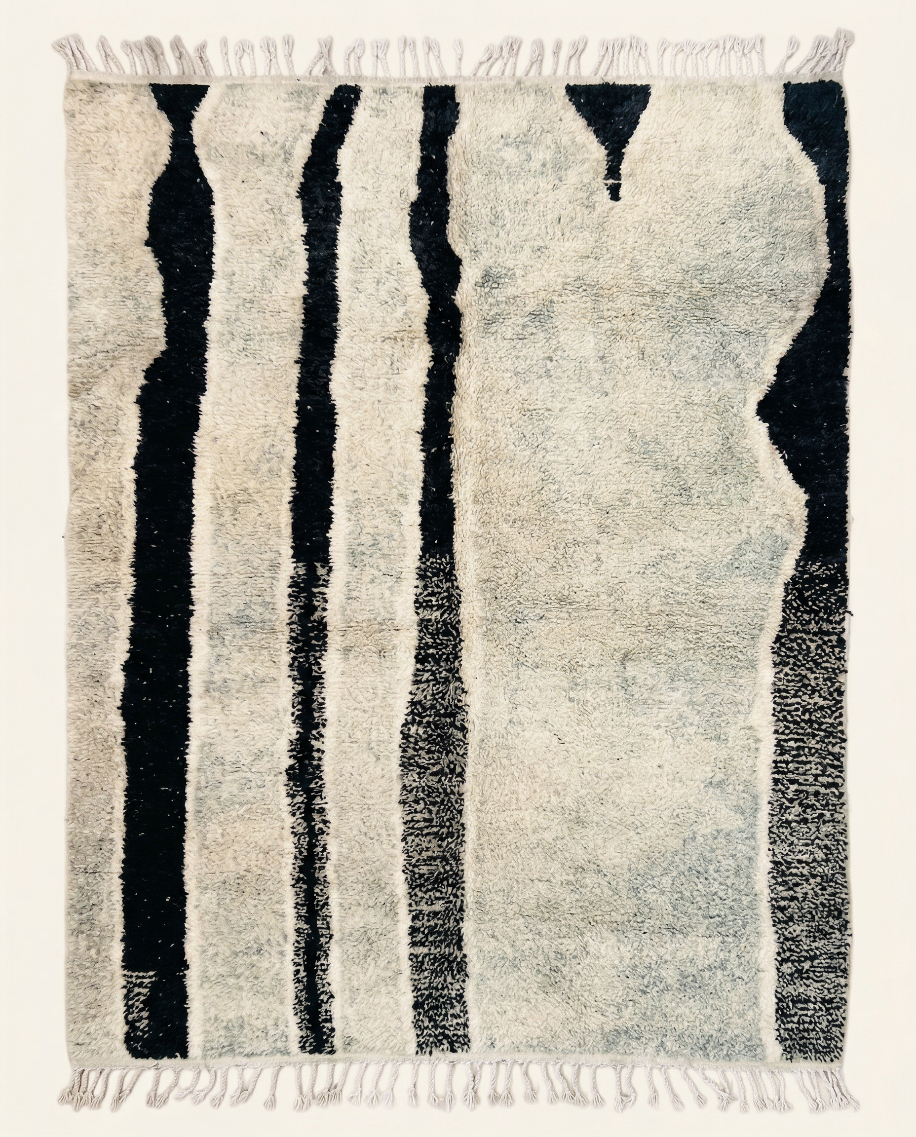 Plush ivory Beni Ourain Moroccan rug with bold irregular black vertical stripes and a high pile, by NURA.
