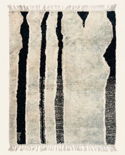 Plush ivory Beni Ourain Moroccan rug with bold irregular black vertical stripes and a high pile, by NURA.