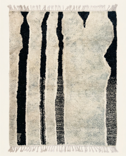 Plush ivory Beni Ourain Moroccan rug with bold irregular black vertical stripes and a high pile, by NURA.