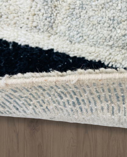 RIHAB Beni Ourain ivory irregular striped field Moroccan rug close-up showing hand-knotted wool texture and pile detail 2, by NURA