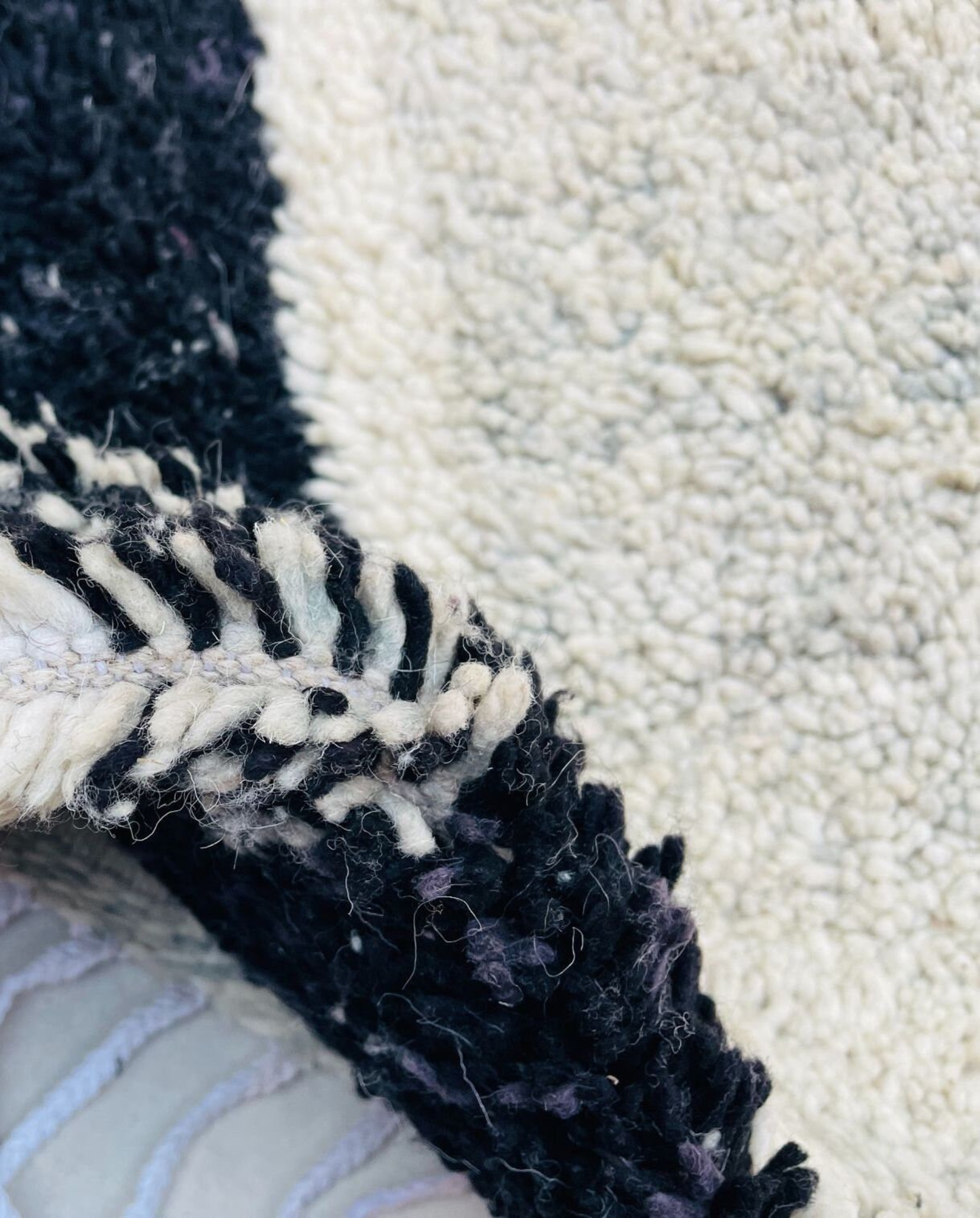 RIHAB Beni Ourain ivory irregular striped field Moroccan rug close-up showing hand-knotted wool texture and pile detail 3, by NURA
