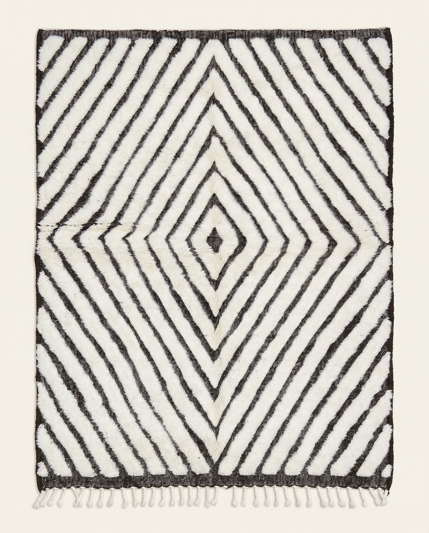 Plush ivory and charcoal Beni Ourain Moroccan rug with a bold concentric diamond pattern and mixed pile texture, by NURA.