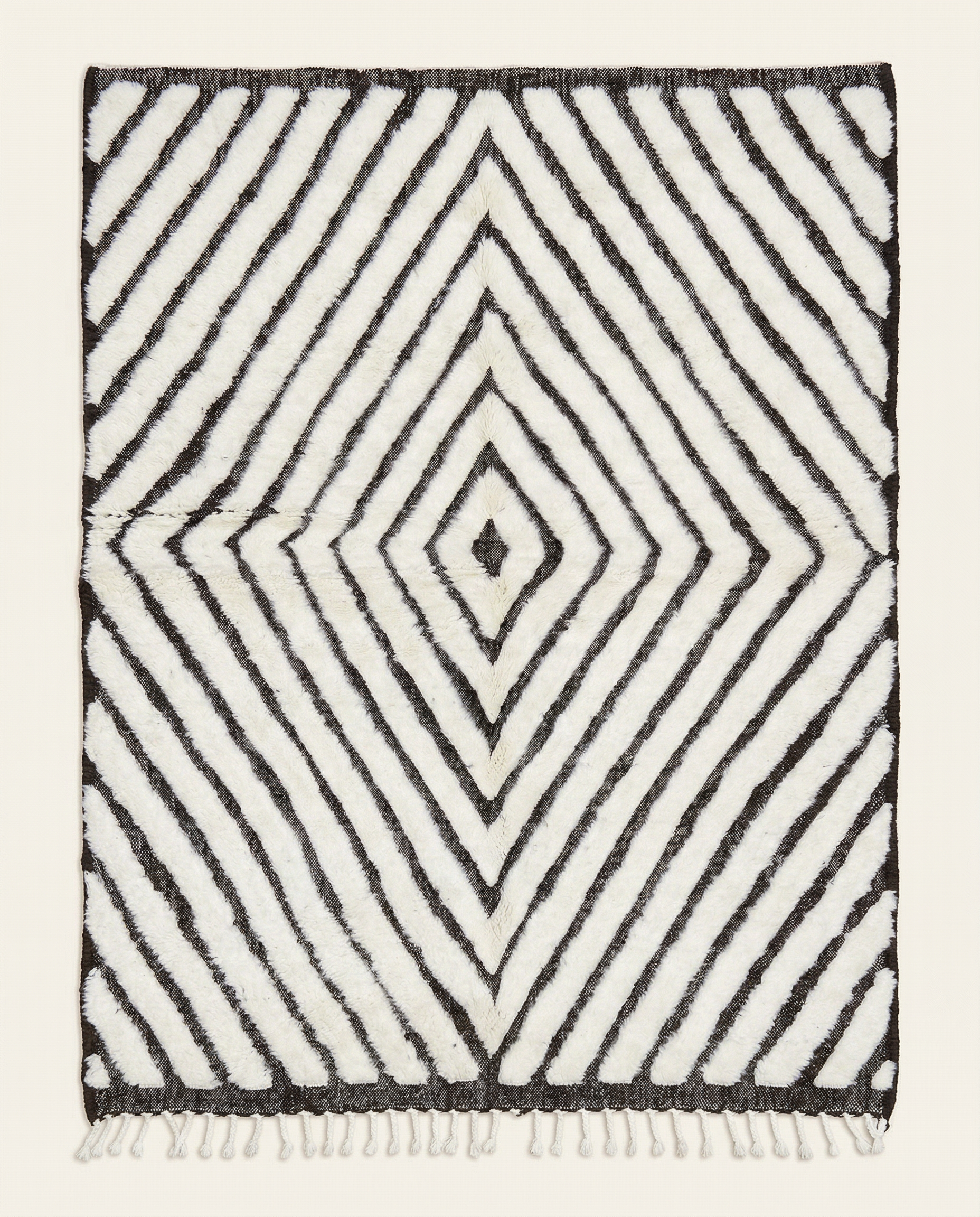 Plush ivory and charcoal Beni Ourain Moroccan rug with a bold concentric diamond pattern and mixed pile texture, by NURA.