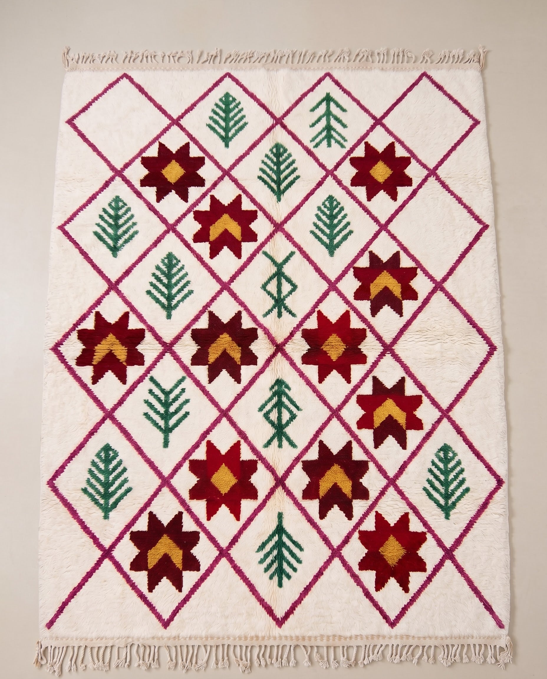 ROUKIA Azilal cream diamond lattice Moroccan rug displayed on a parquet wood floor, showing full fringe and edge detail, by NURA