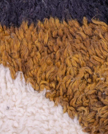 SABAH Azilal cream abstract central motif Moroccan rug close-up showing hand-knotted wool texture and pile detail 1, by NURA