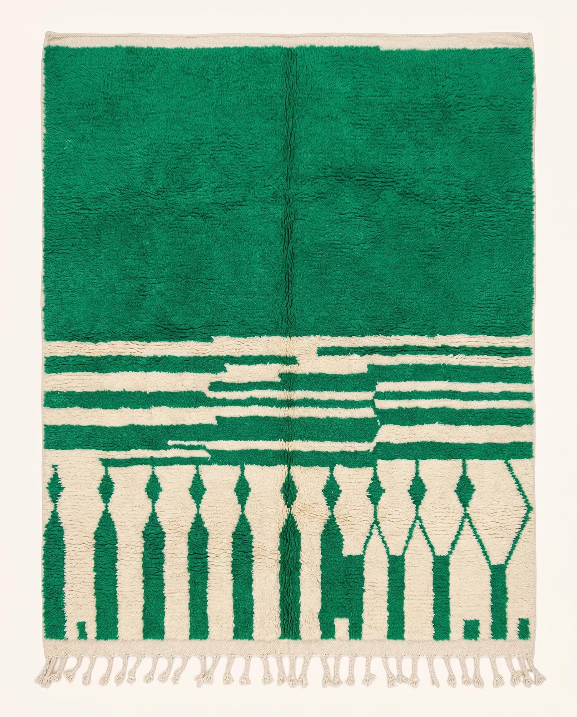 A plush Moroccan wool rug featuring a bold green solid half and a cream half with geometric diamond columns, styled by NURA.