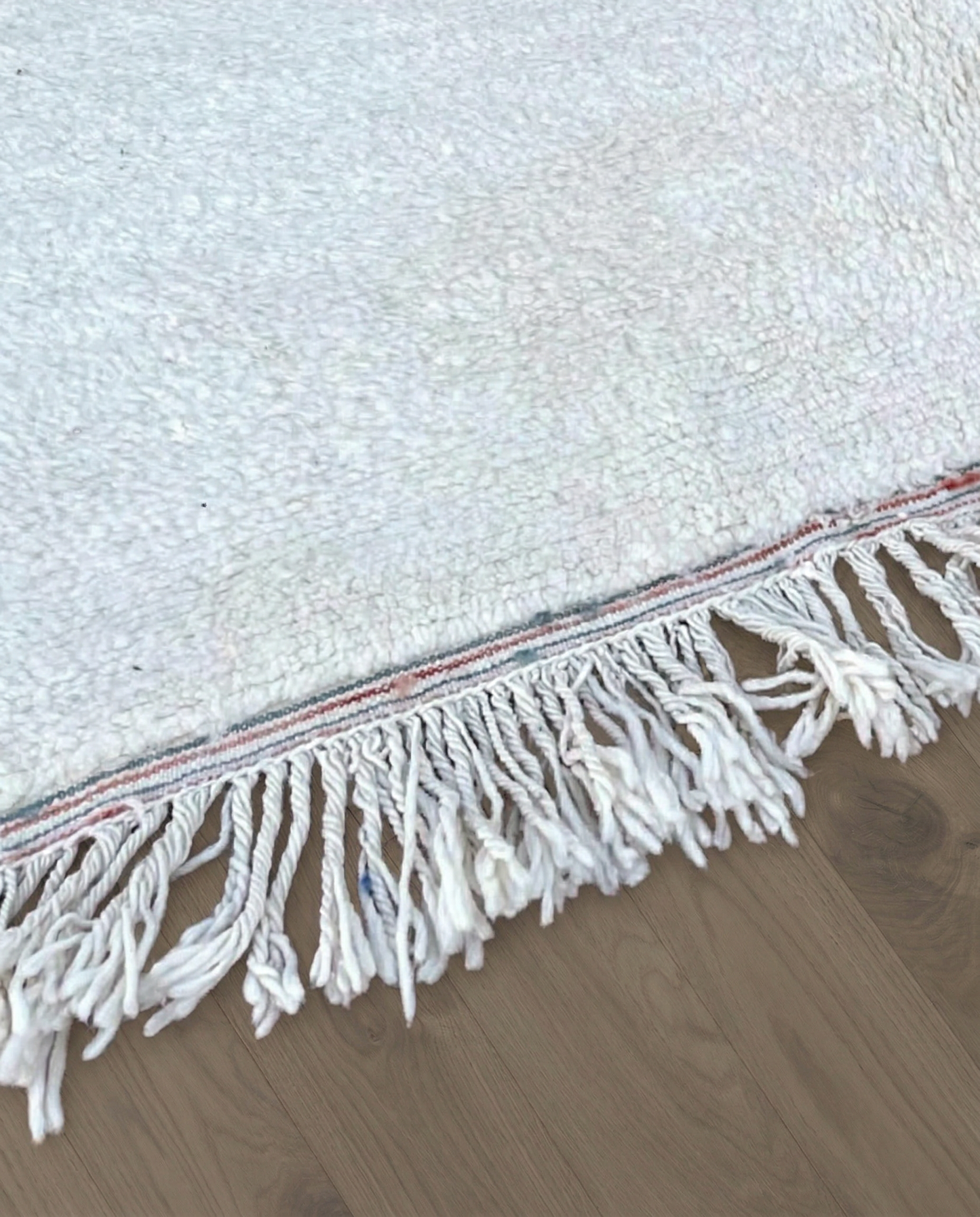 SABRINA Azilal cream abstract color block Moroccan rug close-up of hand-tied fringe and kilim band detail, by NURA