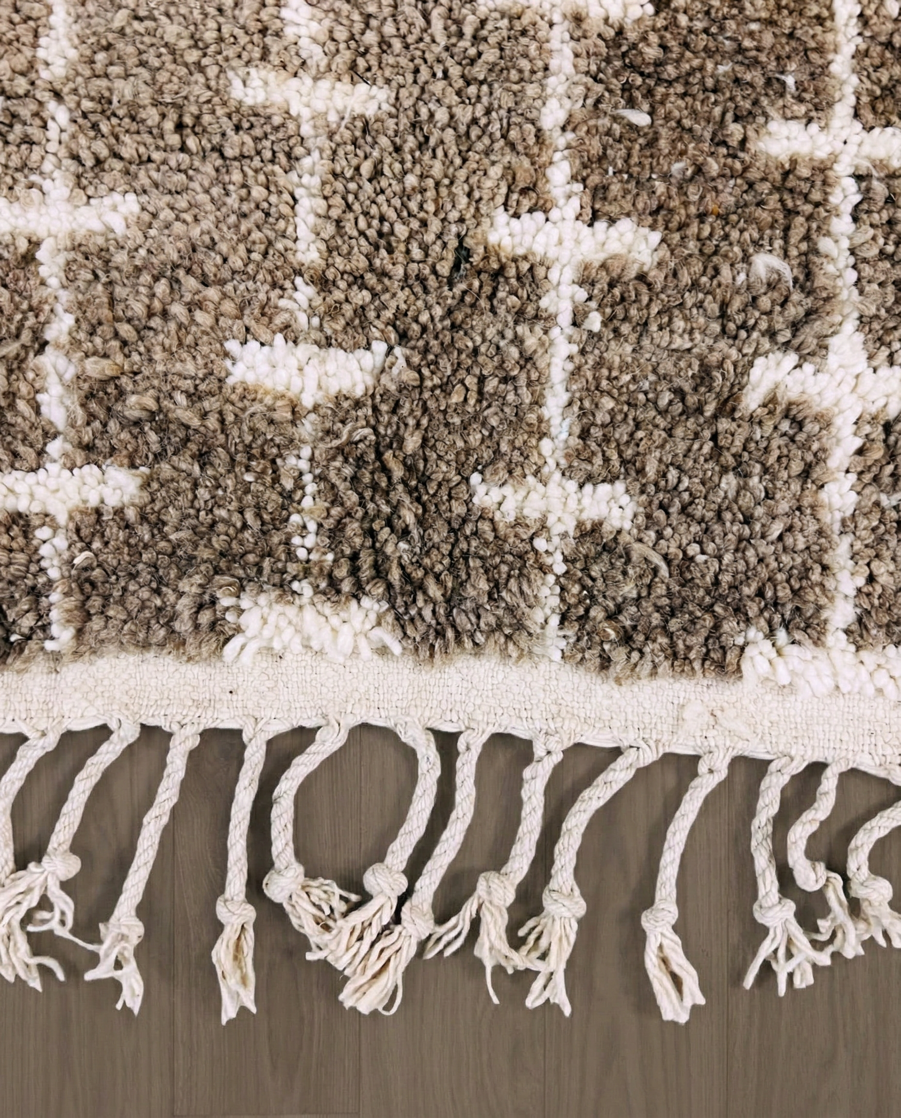 SAFAA Beni Ourain taupe panelled geometric field Moroccan rug close-up of hand-tied fringe and kilim band detail, by NURA
