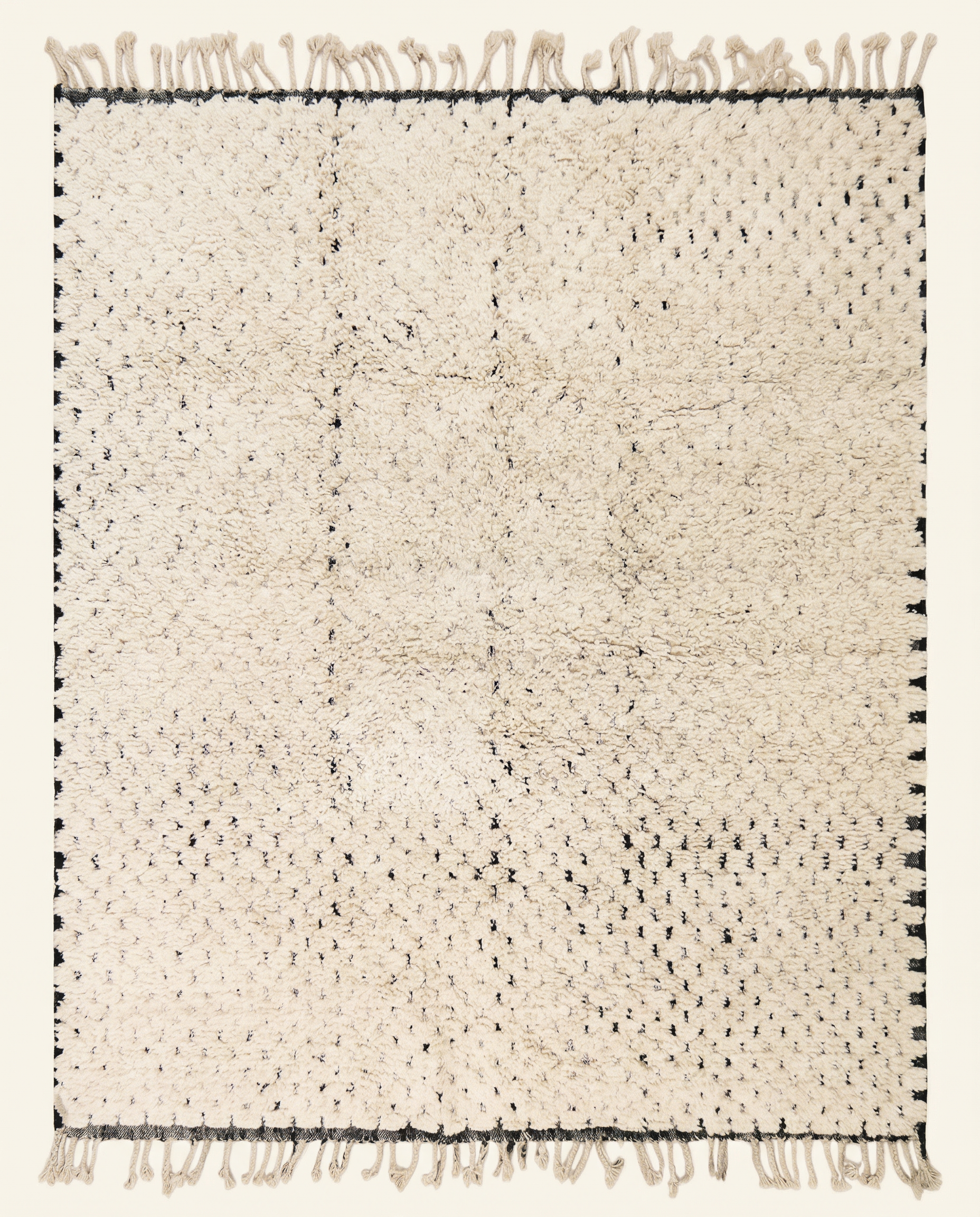 Plush ivory Beni Ourain Moroccan rug with a minimal black dashed line pattern and thick high pile, by NURA.