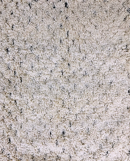 DAMYA Beni Ourain cream dashed line repeat Moroccan rug close-up showing hand-knotted wool texture and pile detail 1, by NURA