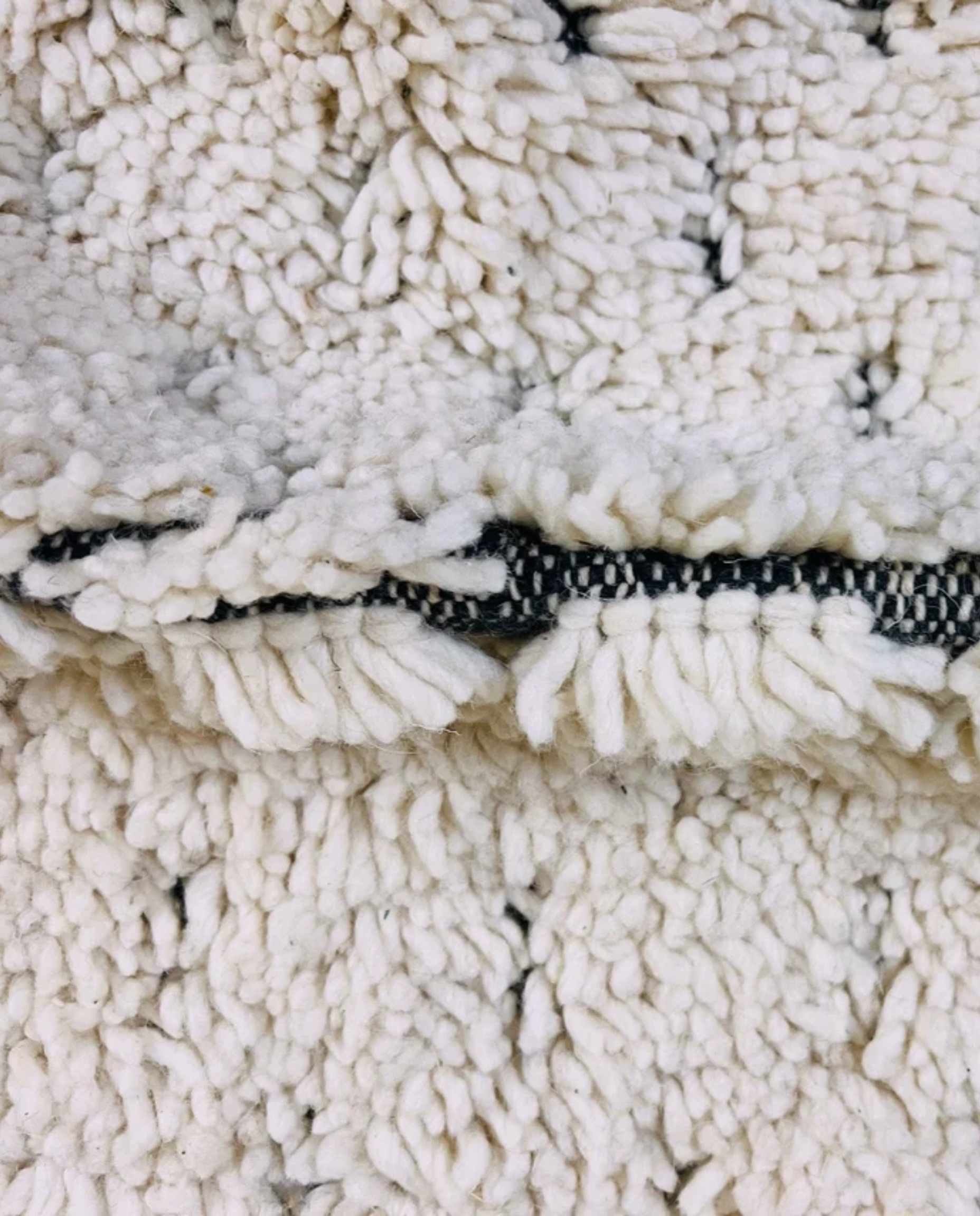 DAMYA Beni Ourain cream dashed line repeat Moroccan rug close-up showing hand-knotted wool texture and pile detail 2, by NURA