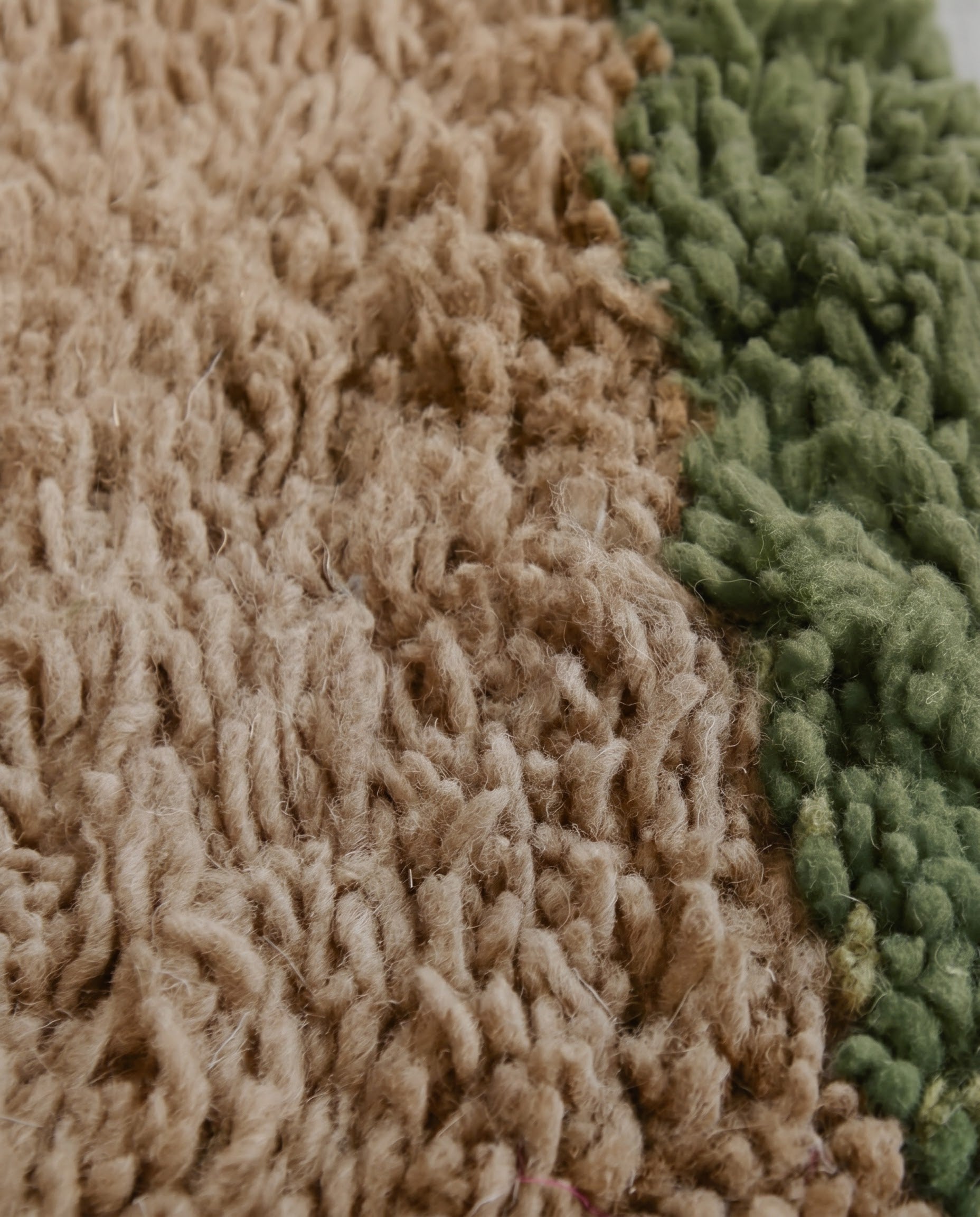 SAIDA Beni Ourain beige bordered field Moroccan rug close-up showing hand-knotted wool texture and pile detail, by NURA