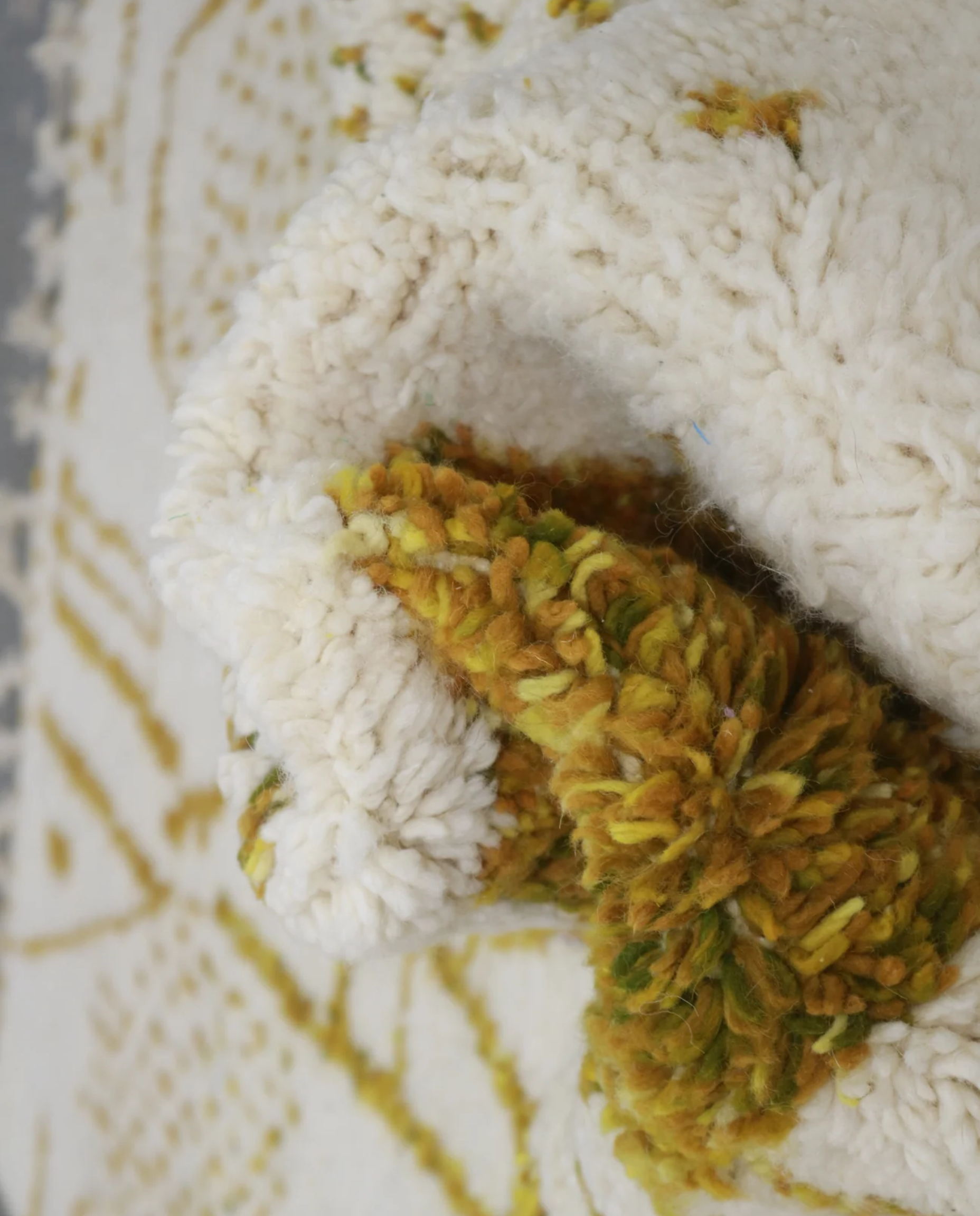 SAJA Beni Ourain cream organic abstract Moroccan rug close-up showing hand-knotted wool texture and pile detail, by NURA
