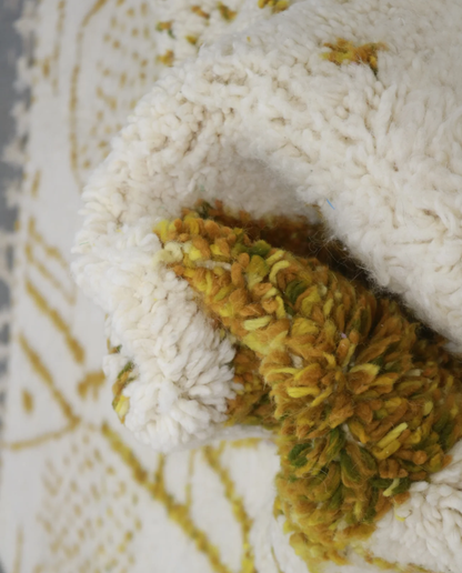 SAJA Beni Ourain cream organic abstract Moroccan rug close-up showing hand-knotted wool texture and pile detail, by NURA