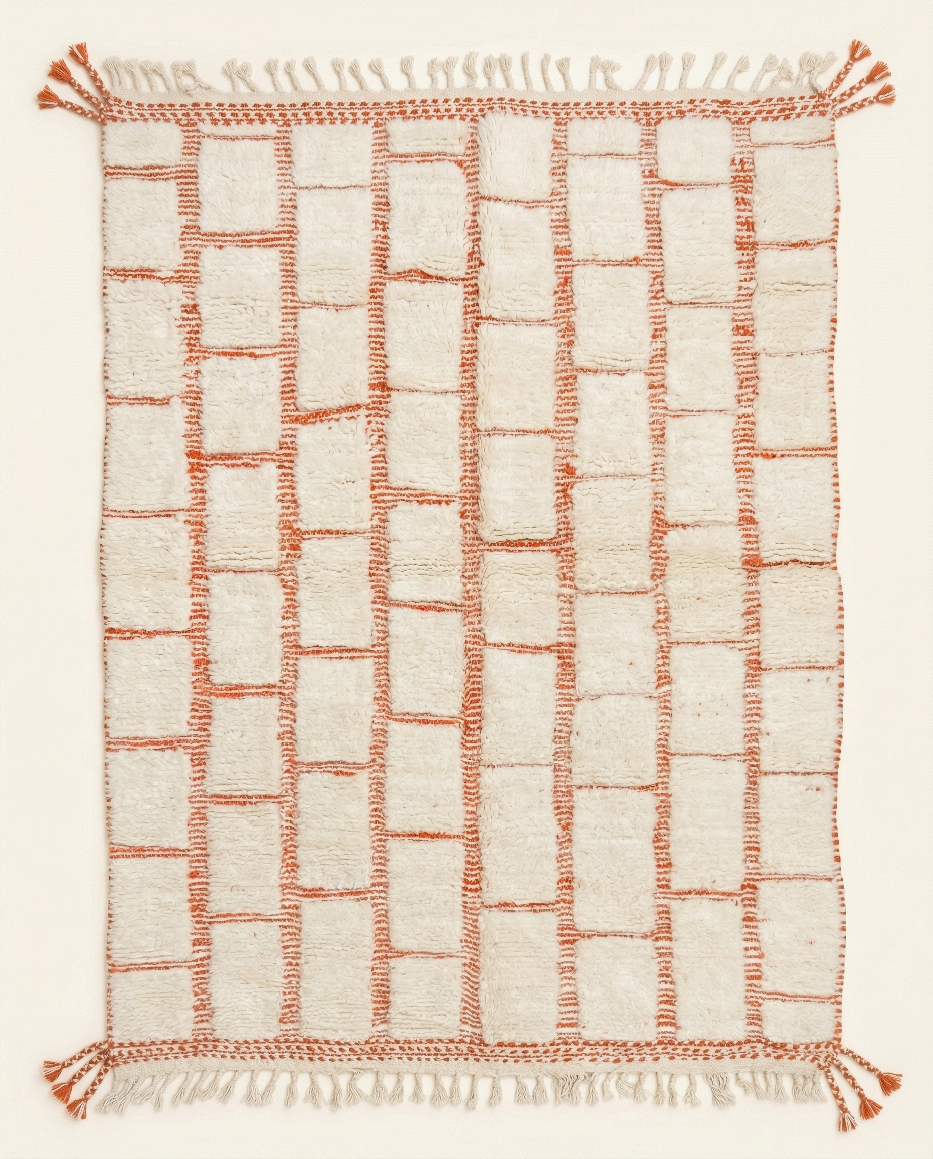 Plush ivory Beni Ourain Moroccan rug with a bold terracotta textured checker grid and braided fringe, by NURA.