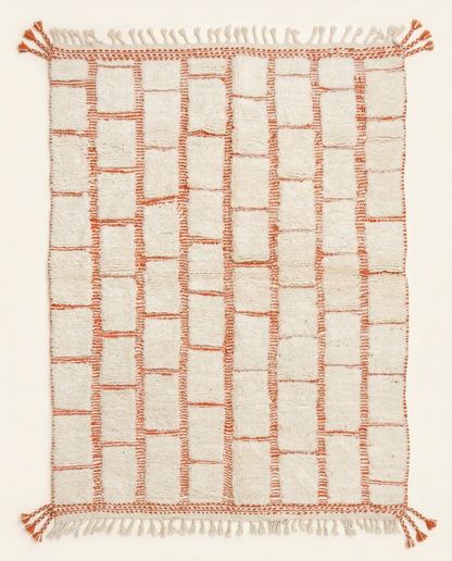 Plush ivory Beni Ourain Moroccan rug with a bold terracotta textured checker grid and braided fringe, by NURA.