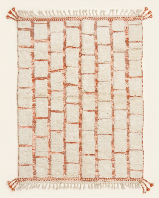 Plush ivory Beni Ourain Moroccan rug with a bold terracotta textured checker grid and braided fringe, by NURA.