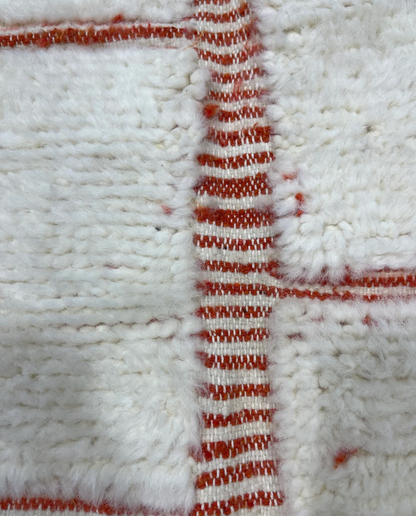 SAKINA Beni Ourain ivory textured checker grid Moroccan rug close-up showing hand-knotted wool texture and pile detail 1, by NURA