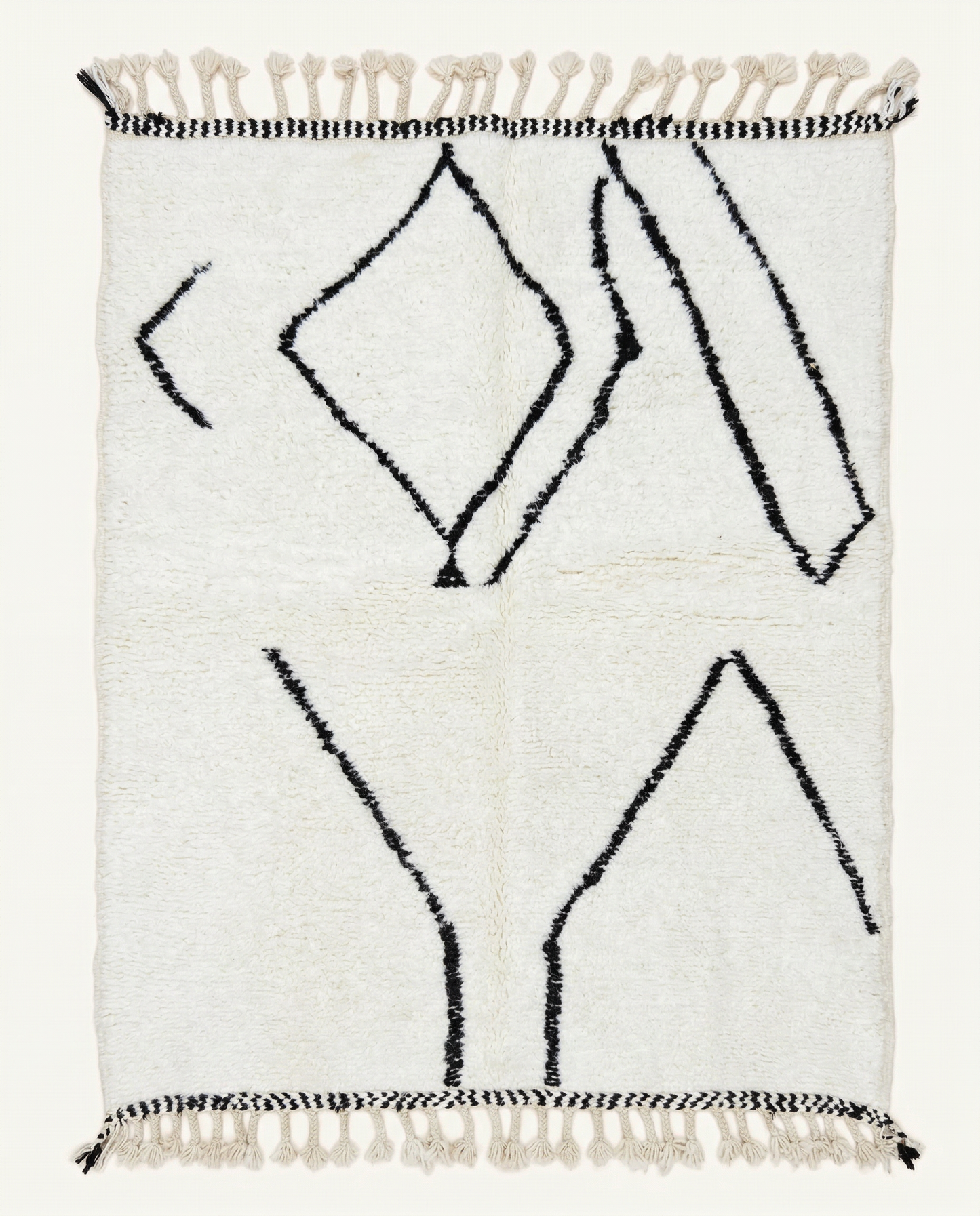Plush ivory Beni Ourain Moroccan rug with bold black abstract diamond motifs and a thick high pile, by NURA.
