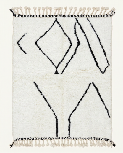 Plush ivory Beni Ourain Moroccan rug with bold black abstract diamond motifs and a thick high pile, by NURA.