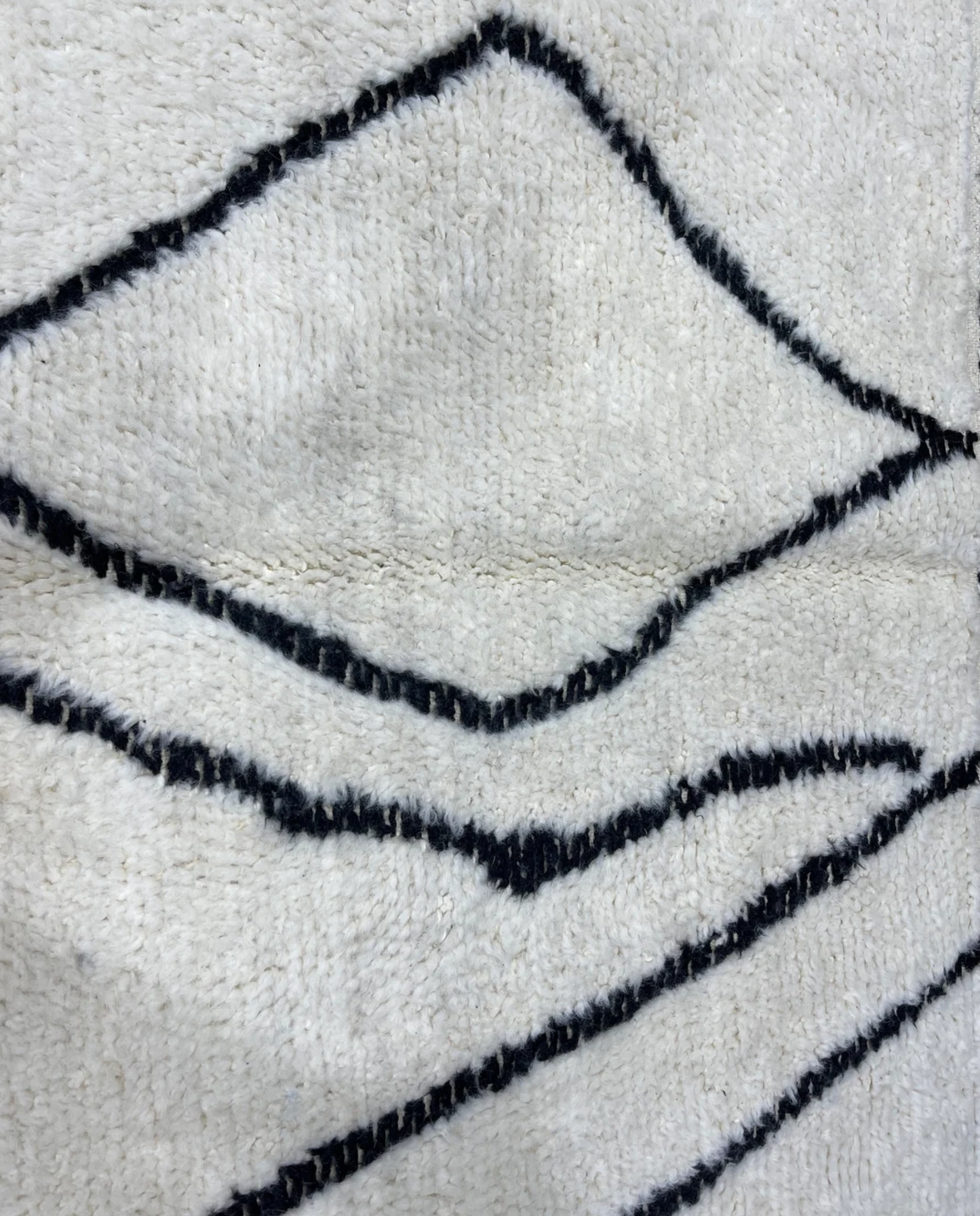 SALIMA Beni Ourain ivory open diamond motif Moroccan rug close-up showing hand-knotted wool texture and pile detail, by NURA