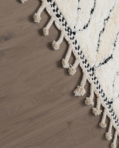 SALMA Beni Ourain cream diamond lattice Moroccan rug close-up of hand-tied fringe and kilim band detail, by NURA