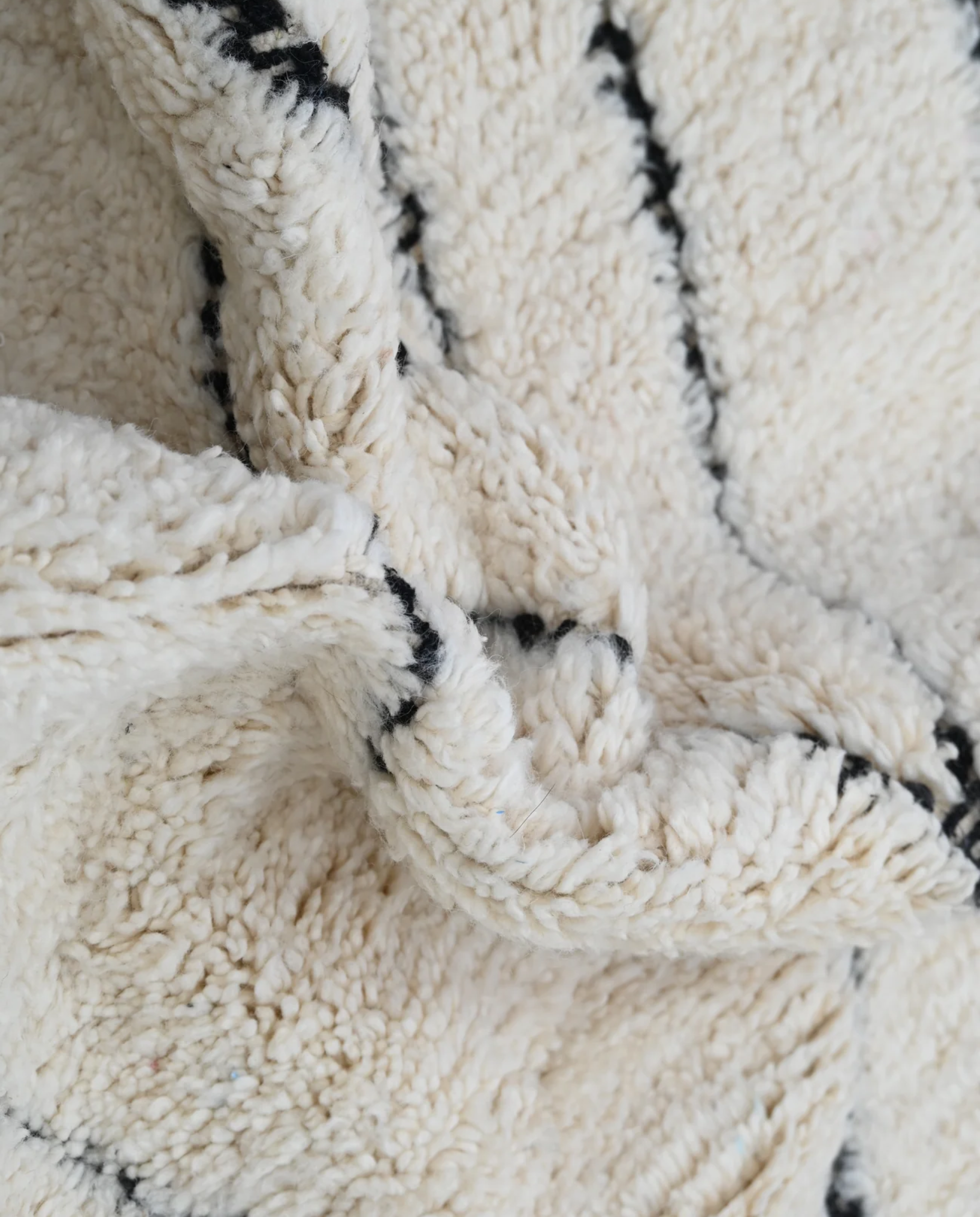 SALMA Beni Ourain cream diamond lattice Moroccan rug close-up showing hand-knotted wool texture and pile detail, by NURA