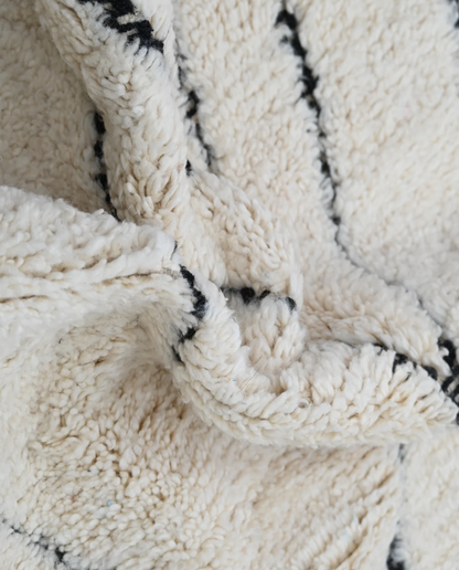 SALMA Beni Ourain cream diamond lattice Moroccan rug close-up showing hand-knotted wool texture and pile detail, by NURA