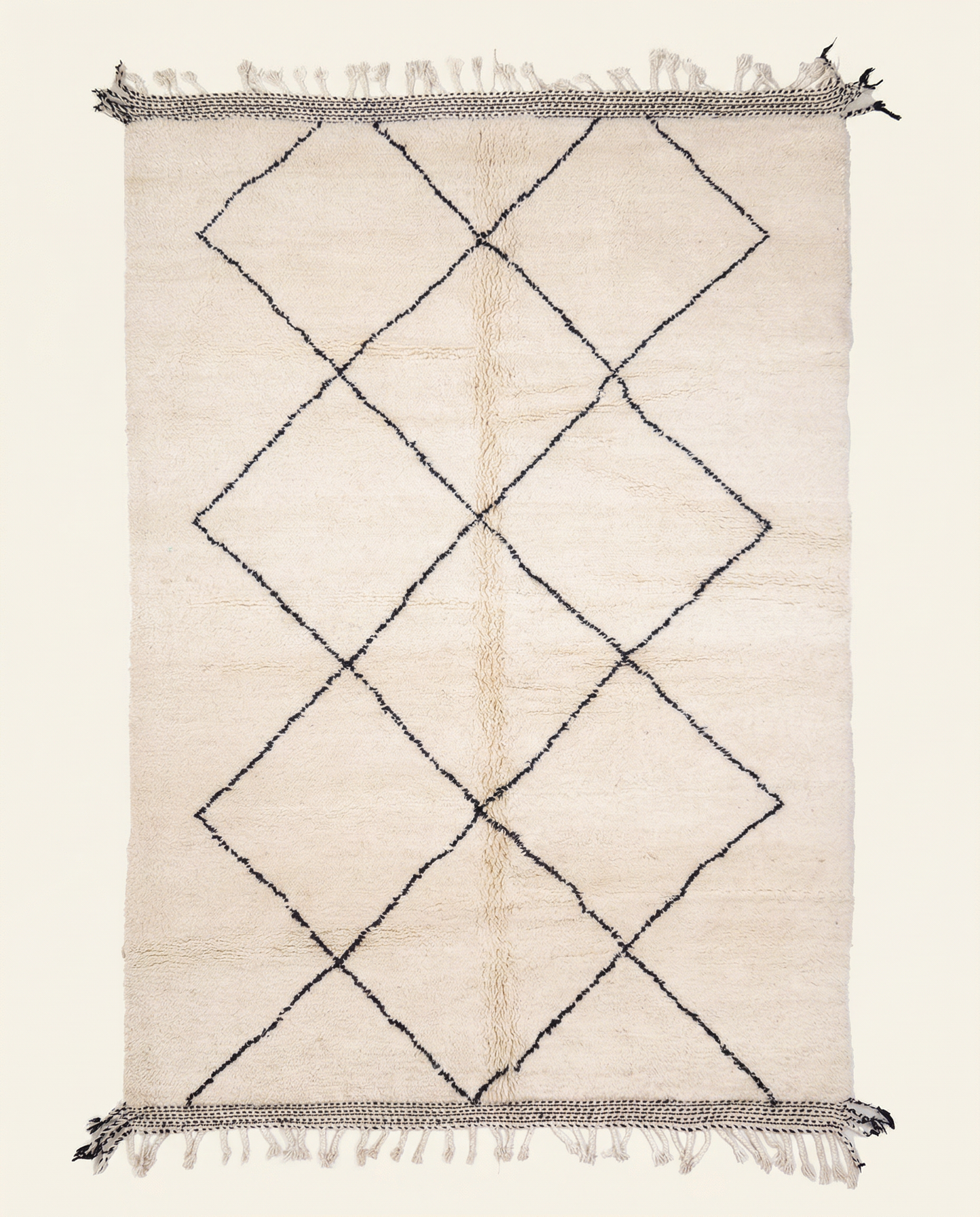Plush ivory Beni Ourain Moroccan rug with a large black diamond lattice and flat-woven end bands, by NURA.