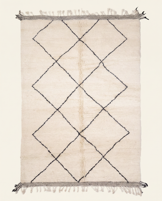Plush ivory Beni Ourain Moroccan rug with a large black diamond lattice and flat-woven end bands, by NURA.