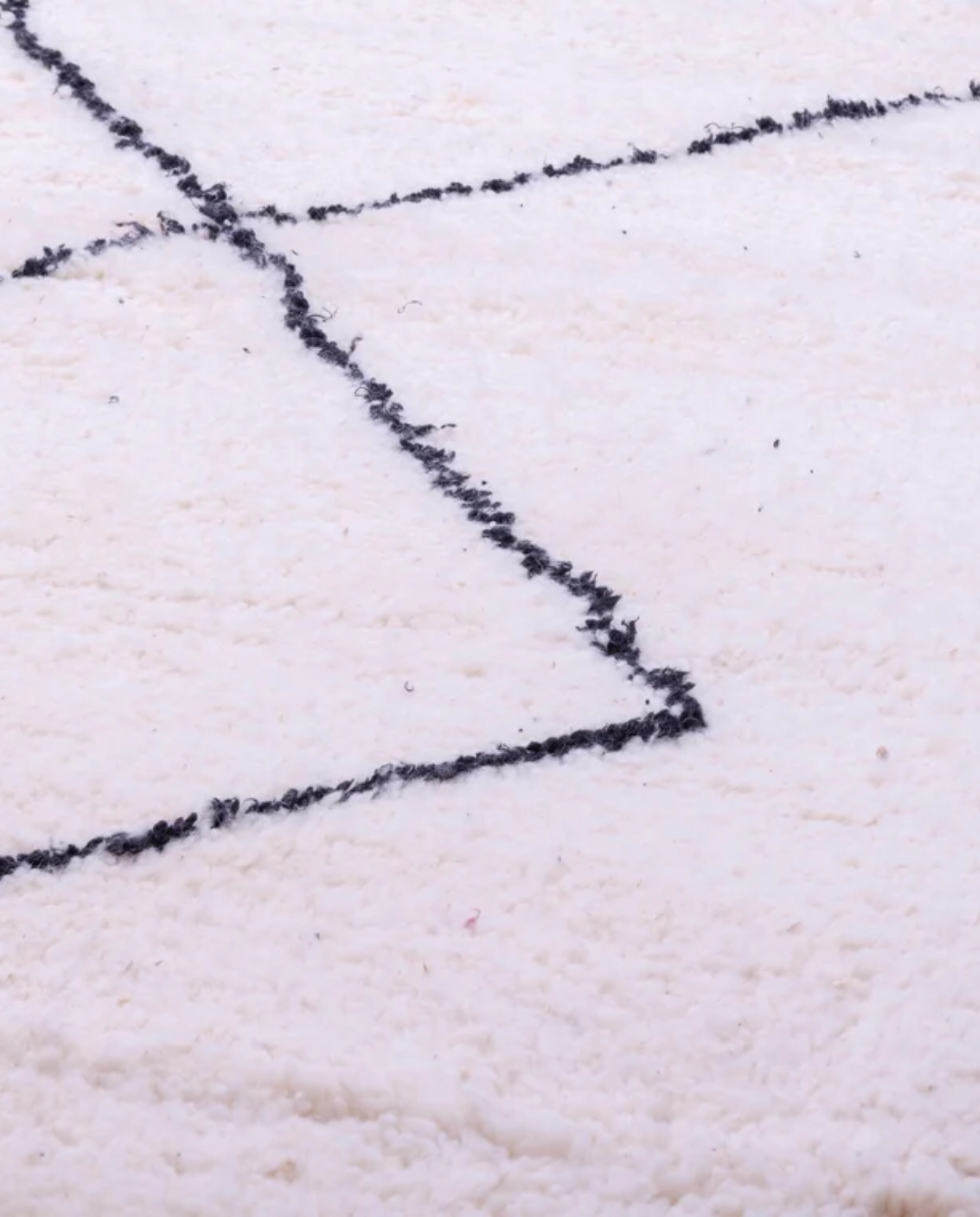 SALWA Beni Ourain ivory diamond lattice Moroccan rug close-up showing hand-knotted wool texture and pile detail, by NURA