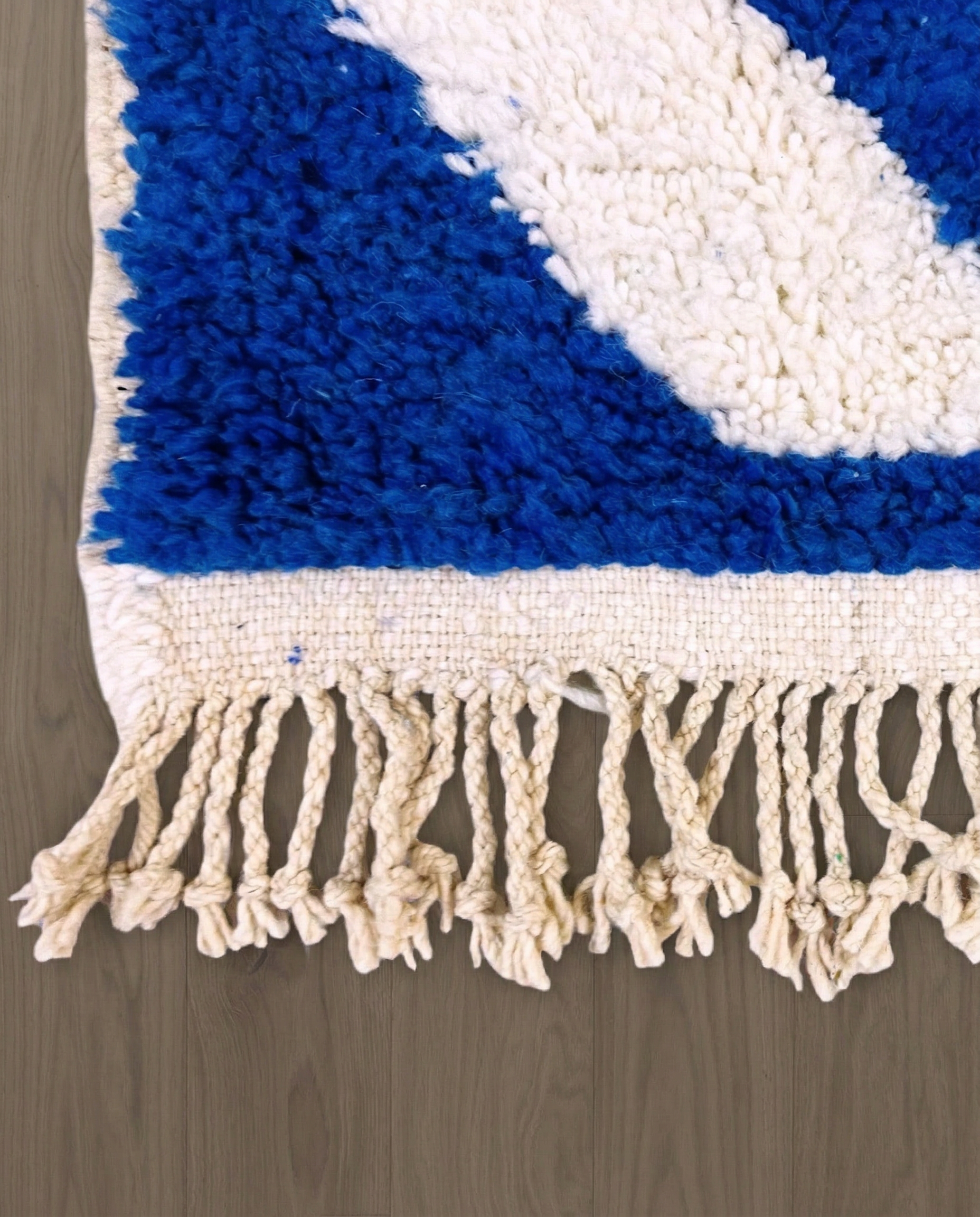 SAMIA Beni Ourain navy graphic arrow bands Moroccan rug close-up of hand-tied fringe and kilim band detail, by NURA