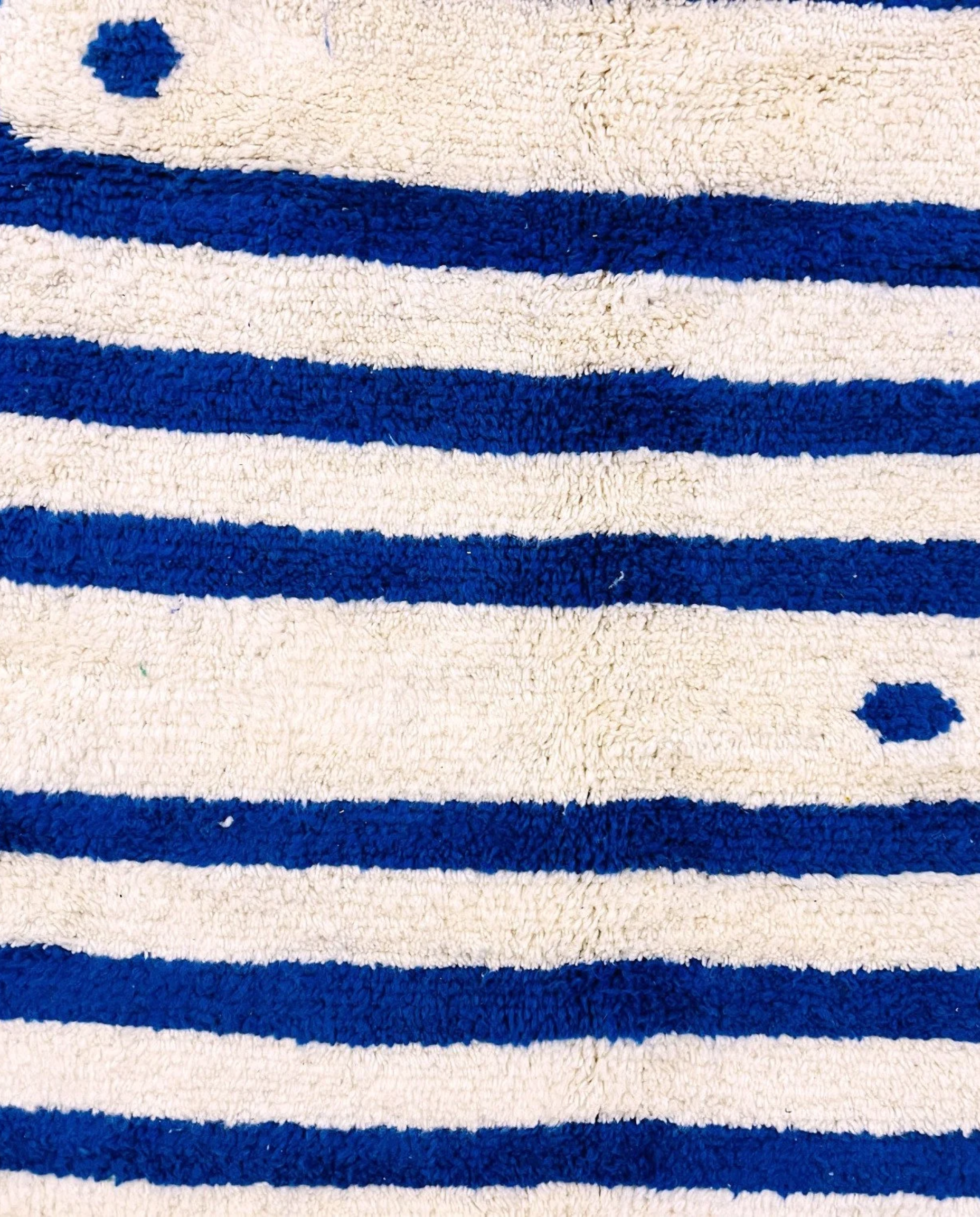 SAMIA Beni Ourain navy graphic arrow bands Moroccan rug close-up showing hand-knotted wool texture and pile detail 1, by NURA