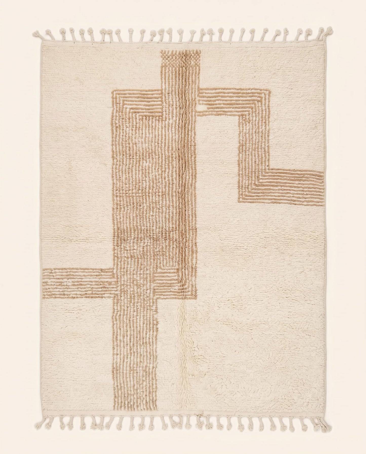 A plush cream Beni Ourain Moroccan rug featuring a modern geometric maze pattern in warm camel wool, crafted by NURA.