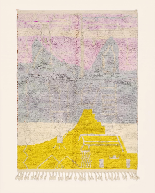 A contemporary Azilal Moroccan rug by NURA with large abstract color blocks in yellow, pink, and cream on a grey wool pile.