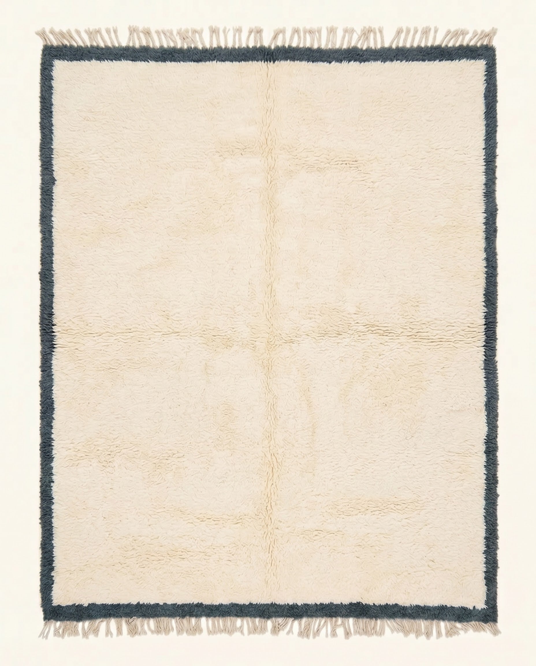 A plush cream Moroccan Beni Ourain rug featuring a thick charcoal border, hand-knotted from soft wool by NURA.
