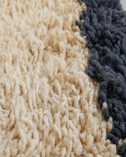 SANAA Beni Ourain cream bordered field Moroccan rug close-up showing hand-knotted wool texture and pile detail, by NURA