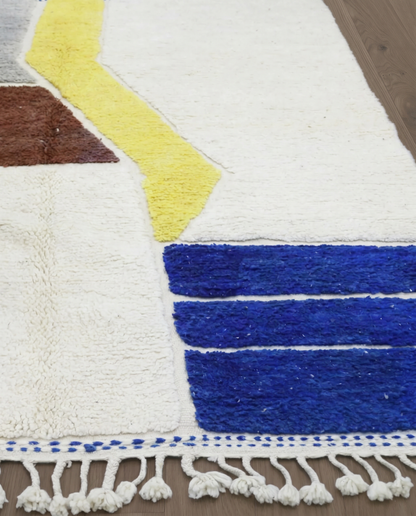 SEKINA Azilal cream abstract color block Moroccan rug close-up of hand-tied fringe and kilim band detail, by NURA