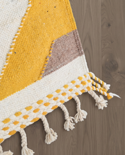 SENANA Taznakht mustard color block Moroccan rug close-up of hand-tied fringe and kilim band detail, by NURA